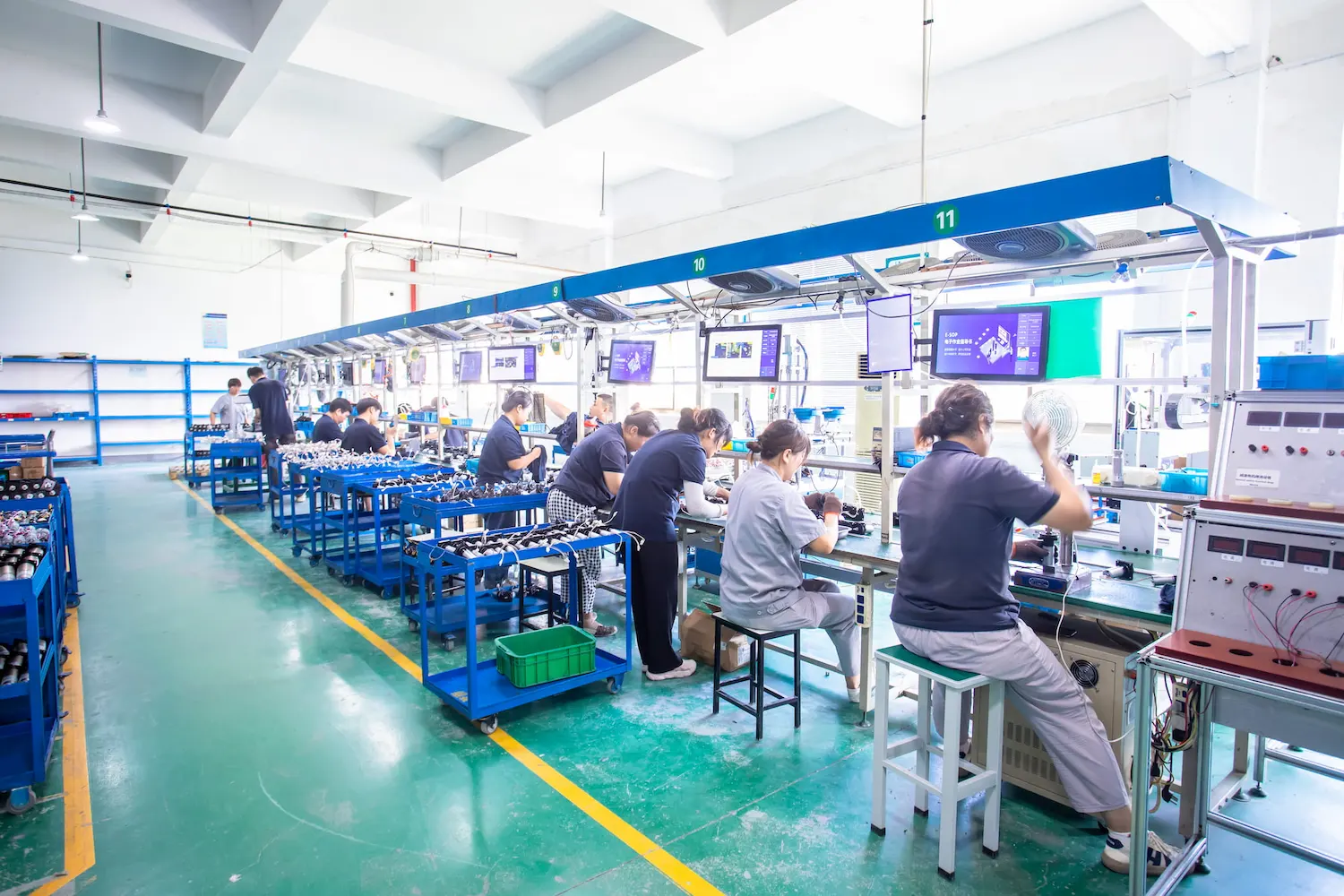 Technicians working at motor assembly stations